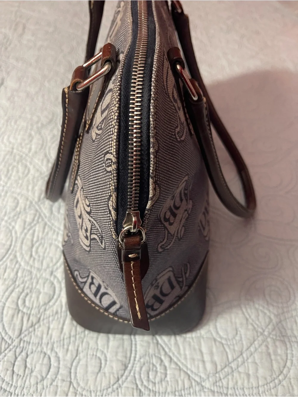 Dooney and Bourke Monogram Denim Donegal Dome Satchel with brown leather trim.